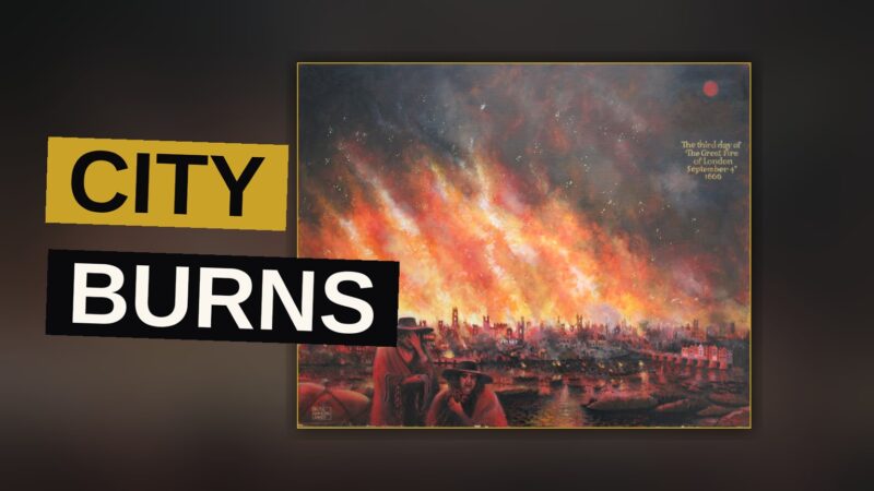 A city street blazes under a dark sky as fire spreads across its rooftops.