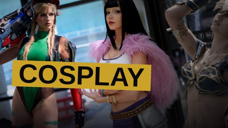 Cosplayers in detailed costumes pose together at a convention, surrounded by crowds and booths.