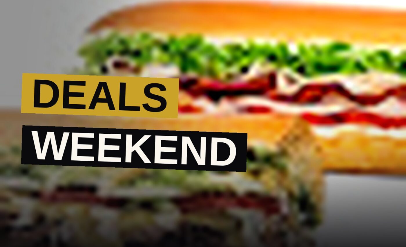 A picnic table piled with fast-food favorites like fried chicken, donuts, and sliders for Labor Day weekend.