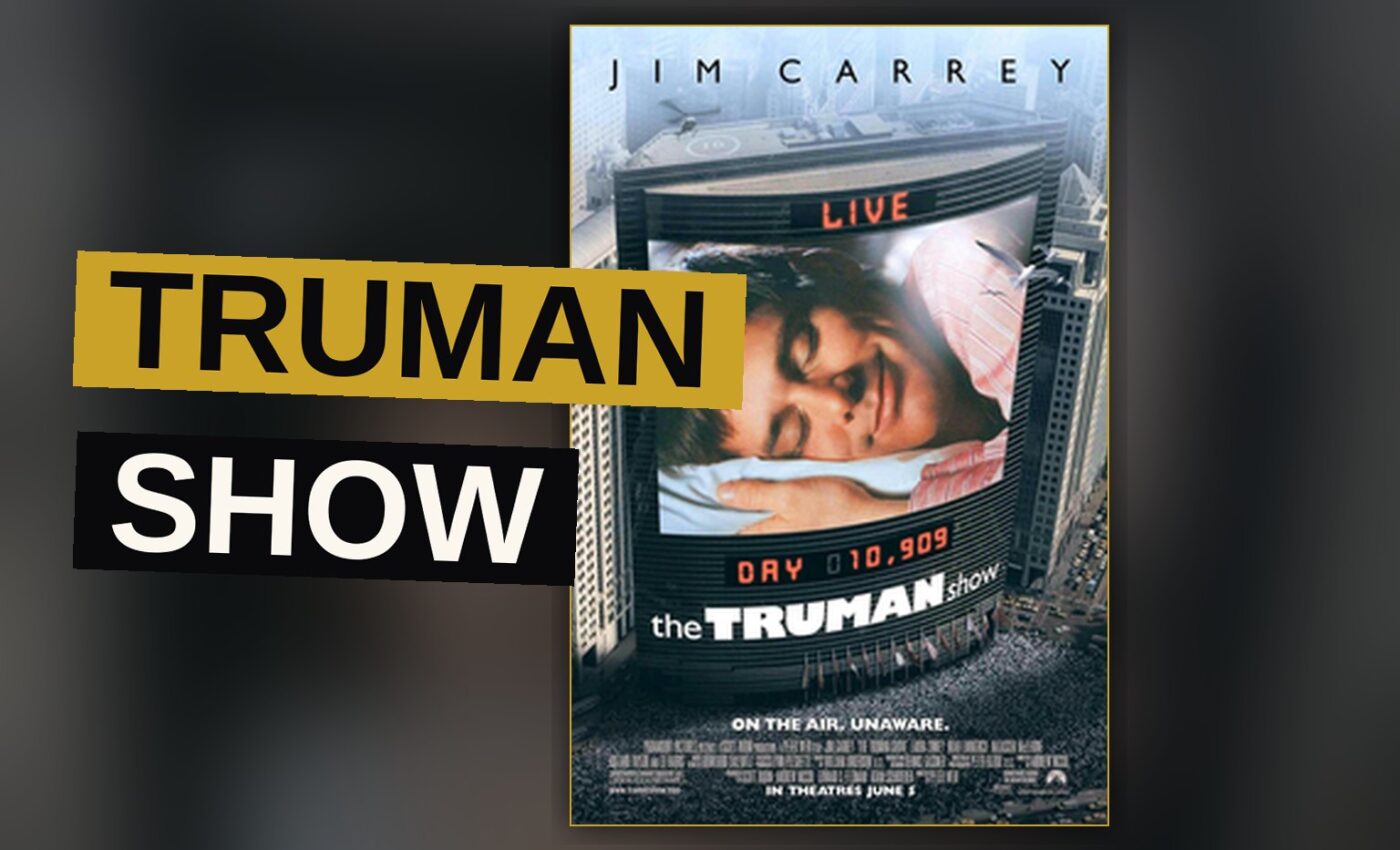 Jim Carrey as Truman Burbank stands before the painted sky wall of his artificial world, reaching out to touch it.