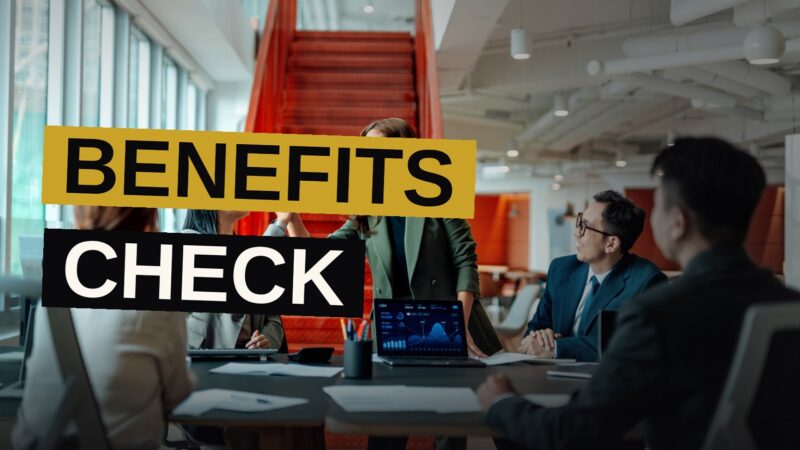 A desk scene with a laptop, coffee, and a checklist, illustrating workplace benefits review.