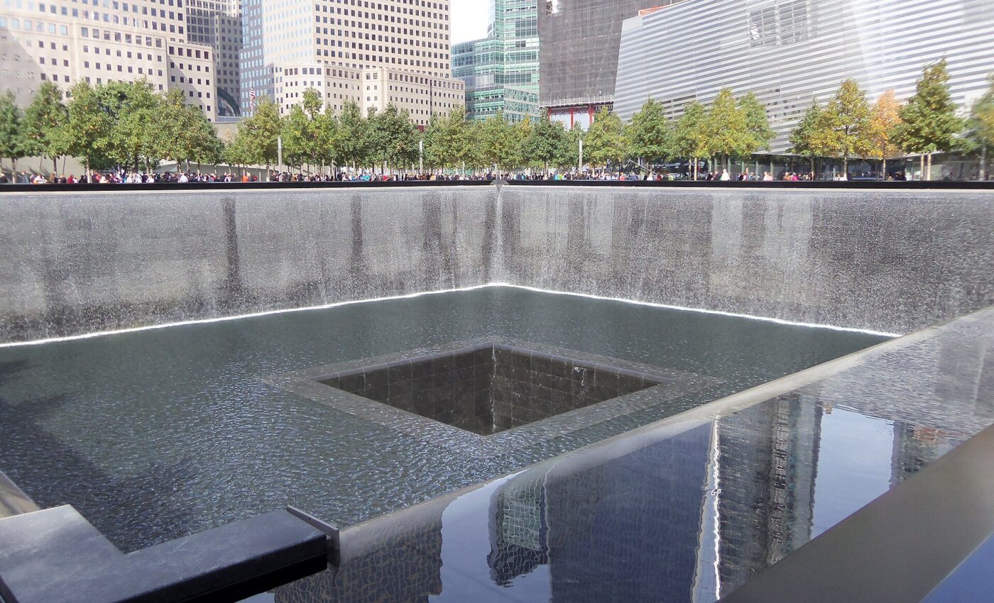 Water falls into the square reflecting pool at the National September 11 Memorial.