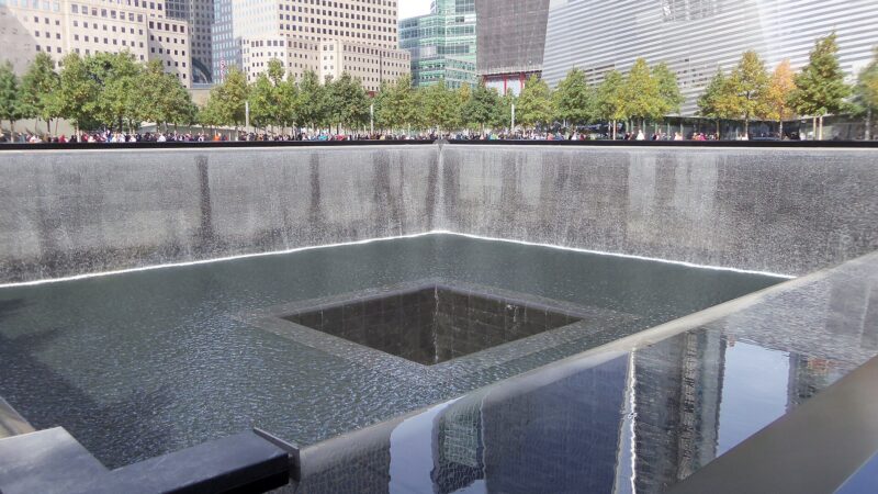 Water falls into the square reflecting pool at the National September 11 Memorial.