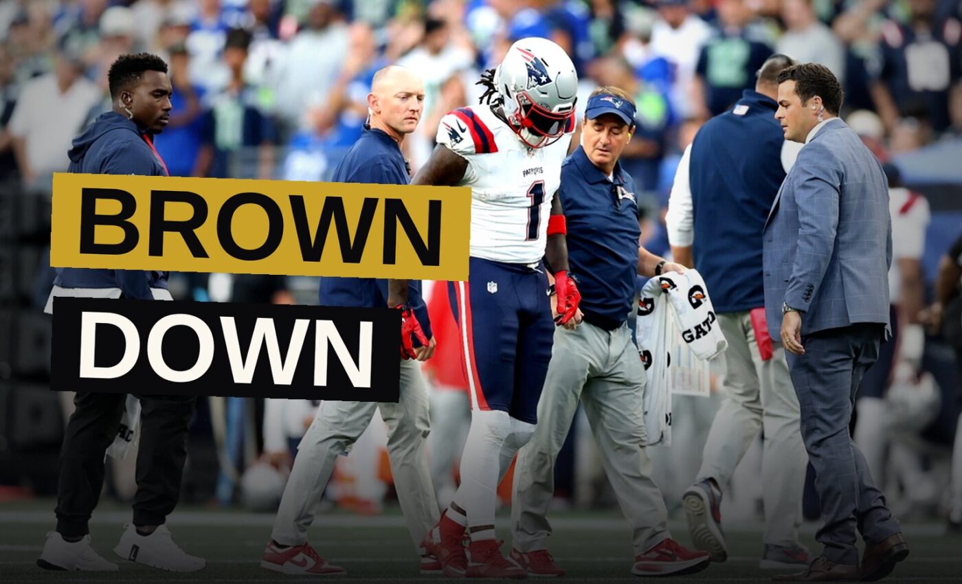 A.J. Brown lies on the field after injuring his ankle, surrounded by Patriots teammates and medical staff.