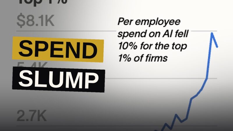 A downward-trending chart glows on a screen in an empty modern office, symbolizing slowing AI spending.