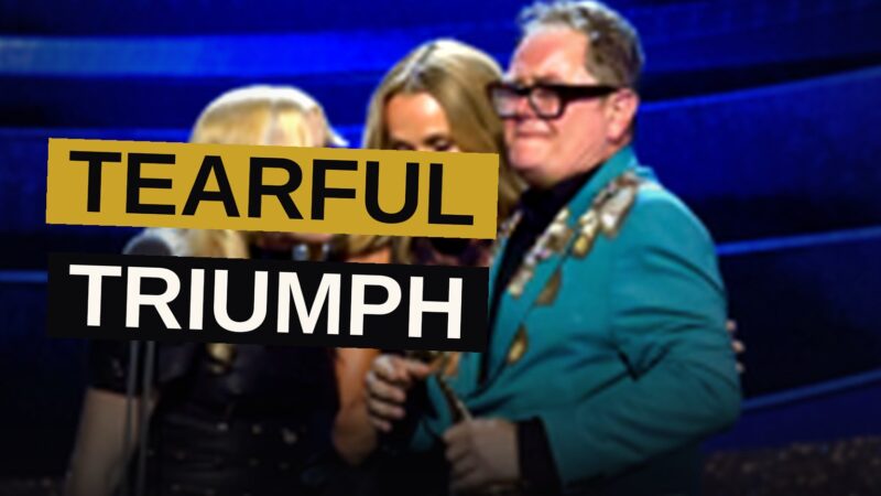 A comic stands upon the lofty stage, his visage suffused with the solemn rapture of unlooked-for triumph.