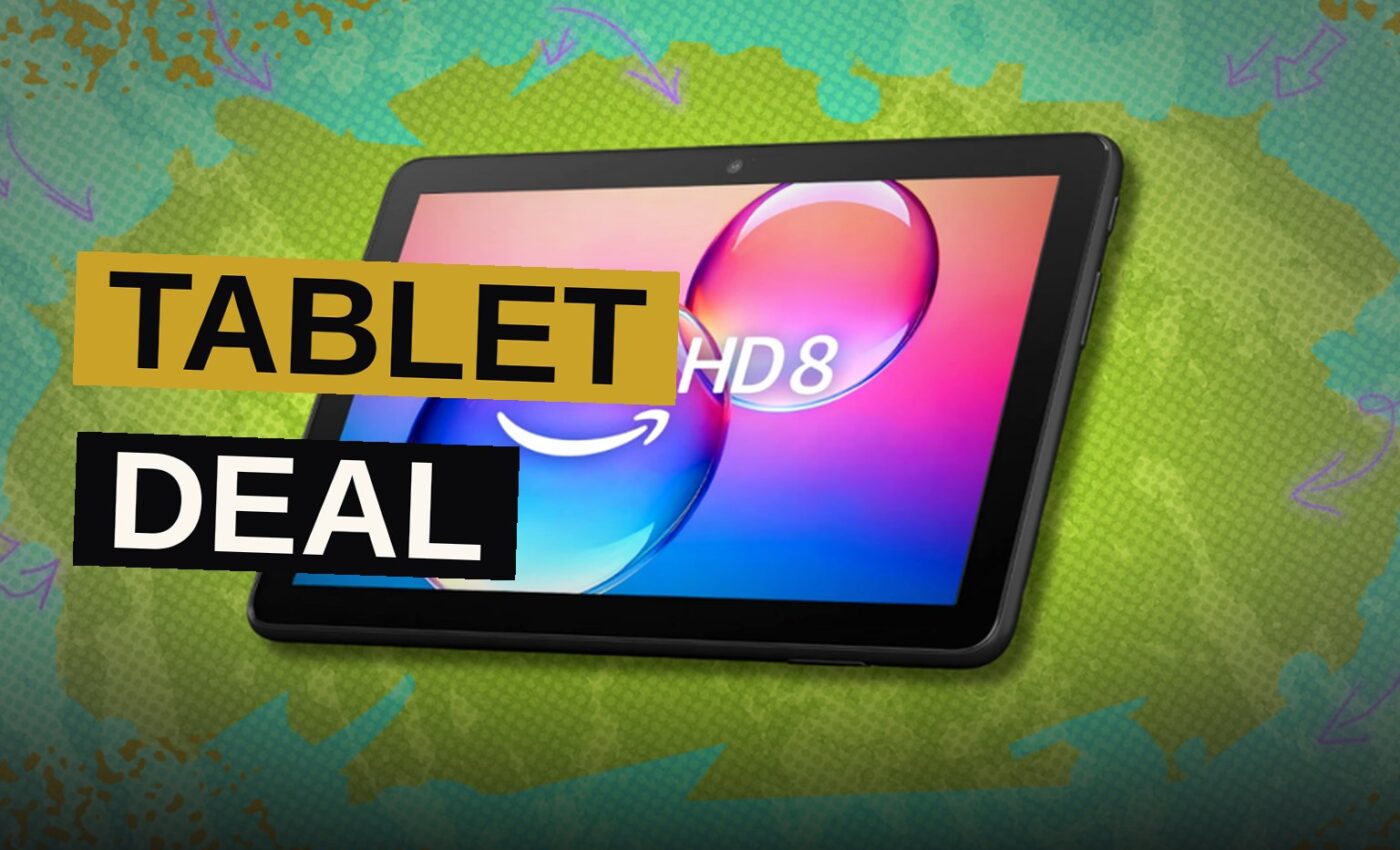 A black Amazon Fire HD 8 tablet displaying colorful apps on its screen, resting on a modern desk.