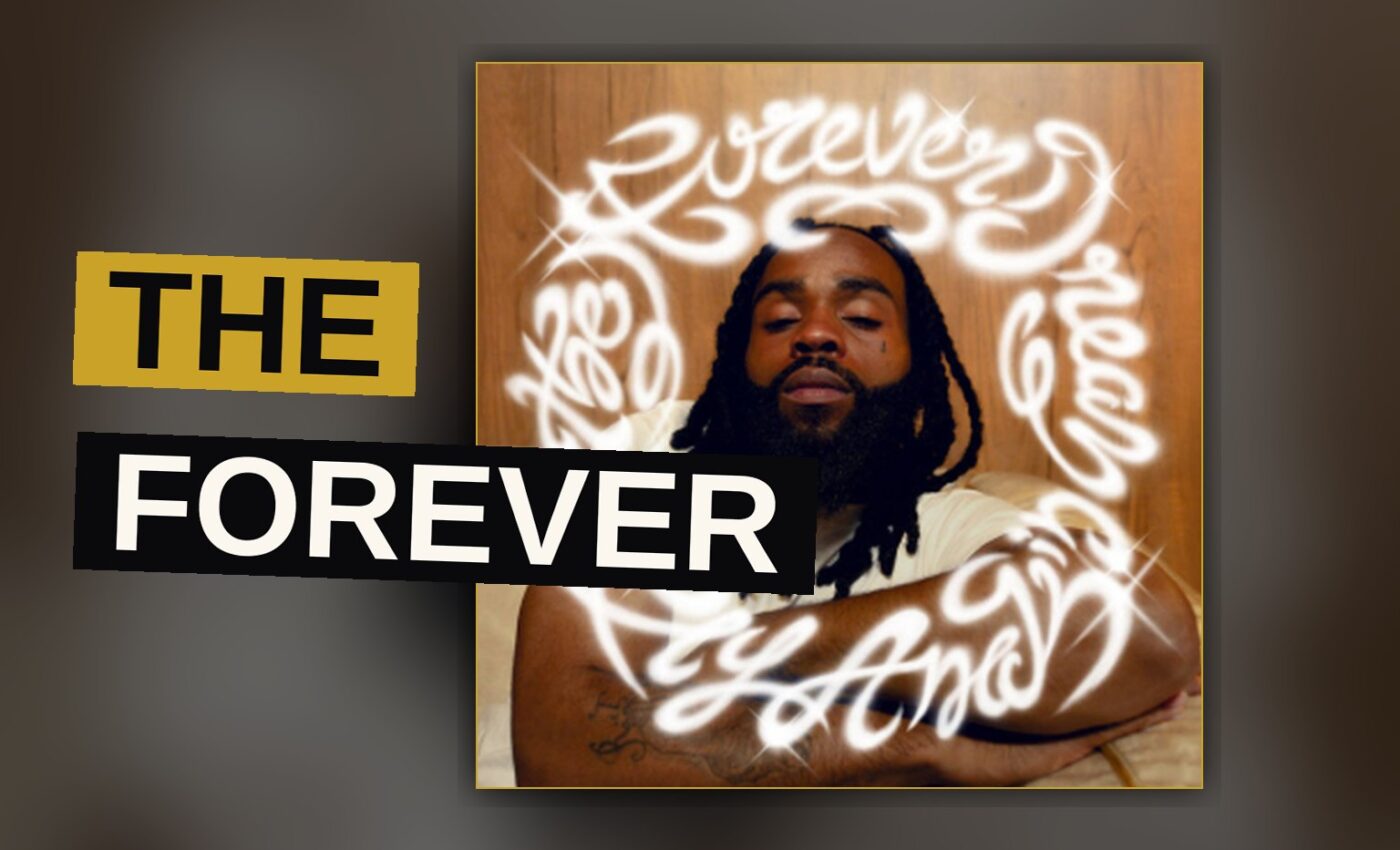 Two hip-hop artists share a microphone in a warm, dimly lit studio.