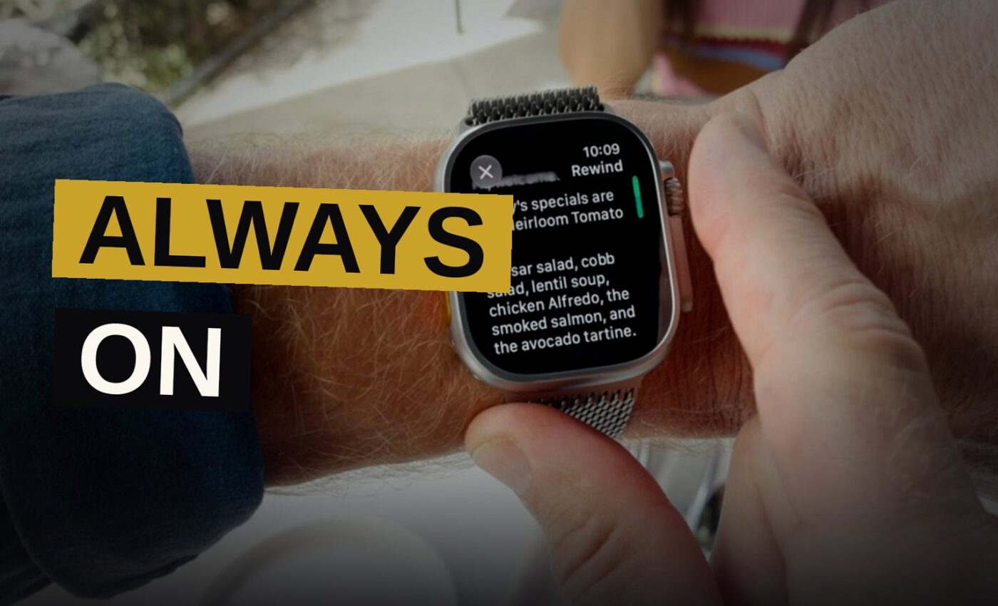 A person wearing a smartwatch in a cafe, with a glowing microphone symbol on the watch face, as other patrons chat in the background.