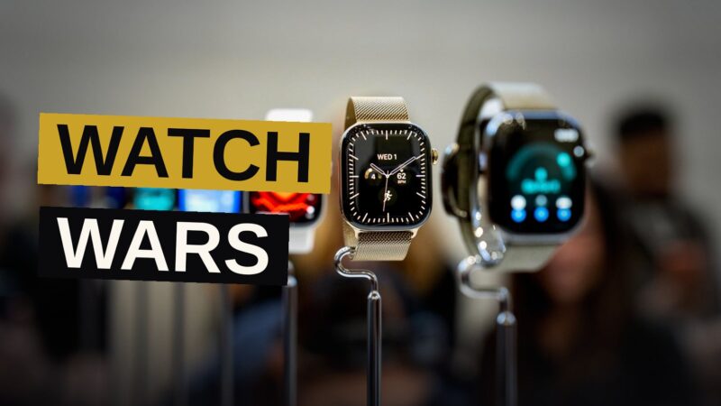 Two modern smartwatches, one with a white ceramic case and one with a dark titanium case, displayed side by side on a neutral background.