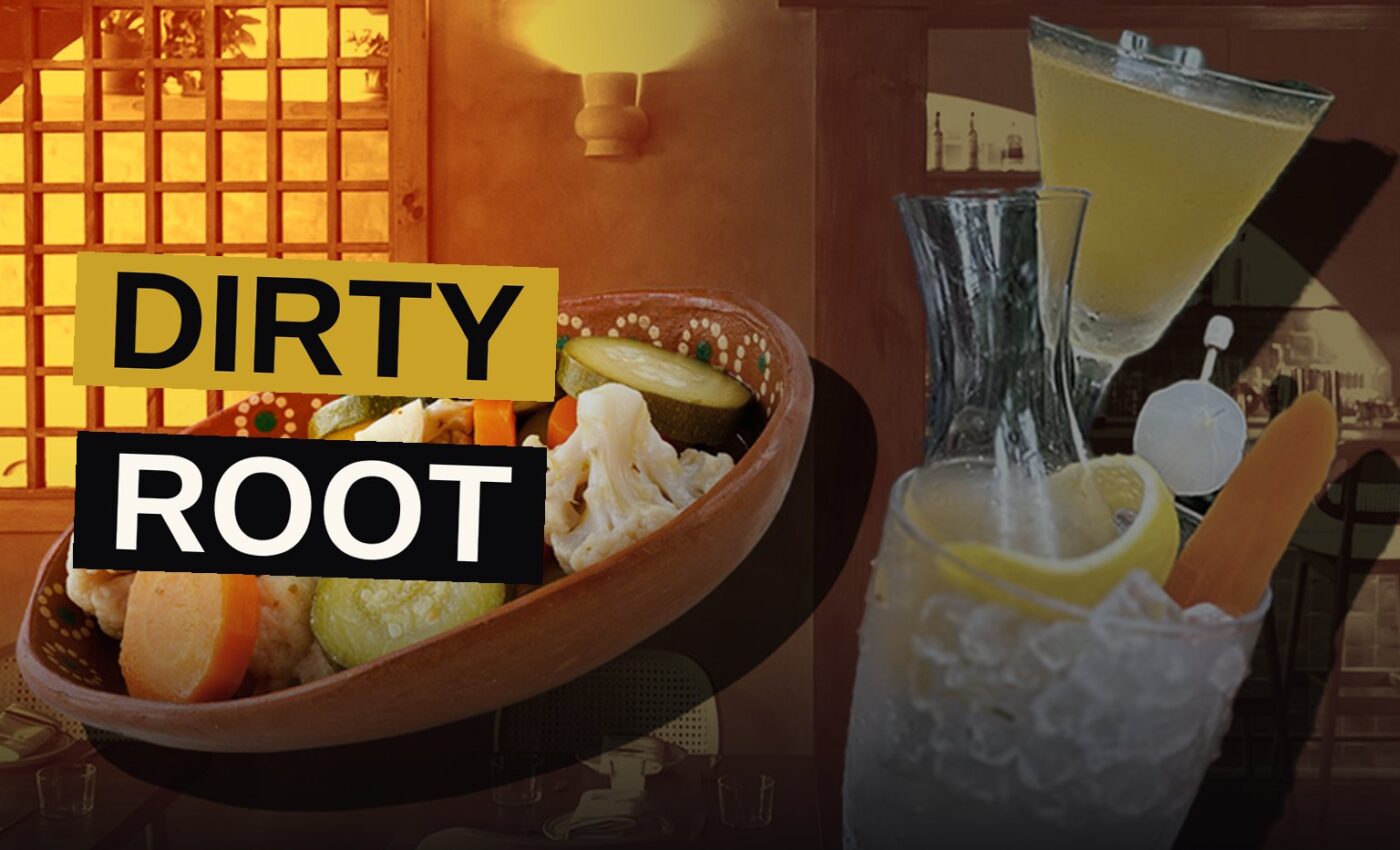 A vibrant orange Dirty Root cocktail in a glass, garnished with a lemon twist, pickled carrot, and cocktail onion.