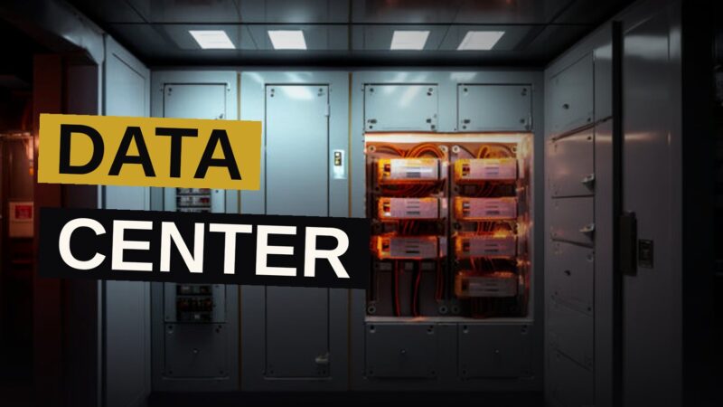 Interior of a modern data center with server racks and overhead HVAC ductwork.
