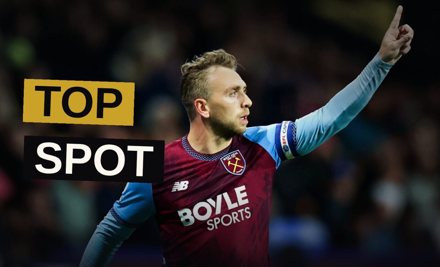 A striker in claret and blue leaps in triumph after striking the winning goal beneath the stadium lights.