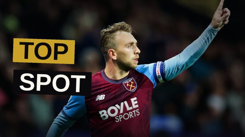 A striker in claret and blue leaps in triumph after striking the winning goal beneath the stadium lights.