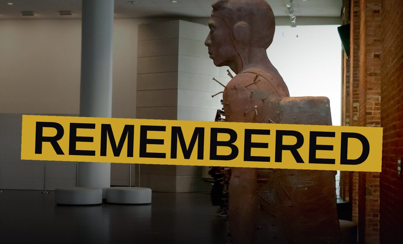 A sculpture of a Black military pilot pierced by nails stands on a pedestal in the Brooklyn Museum's bright lobby.