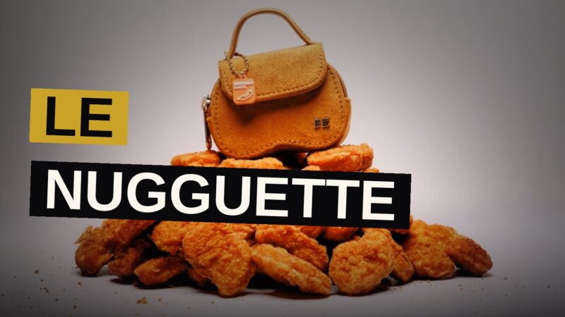 A small bag shaped like a chicken nugget with gold charms beside it.