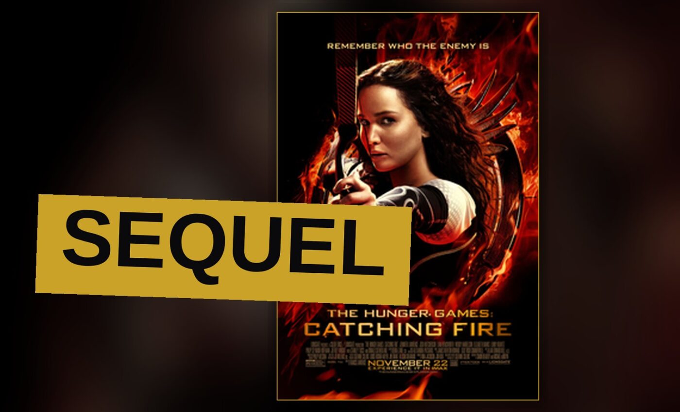 Katniss Everdeen stands in a futuristic arena, bow raised, surrounded by jungle and a glowing force field.