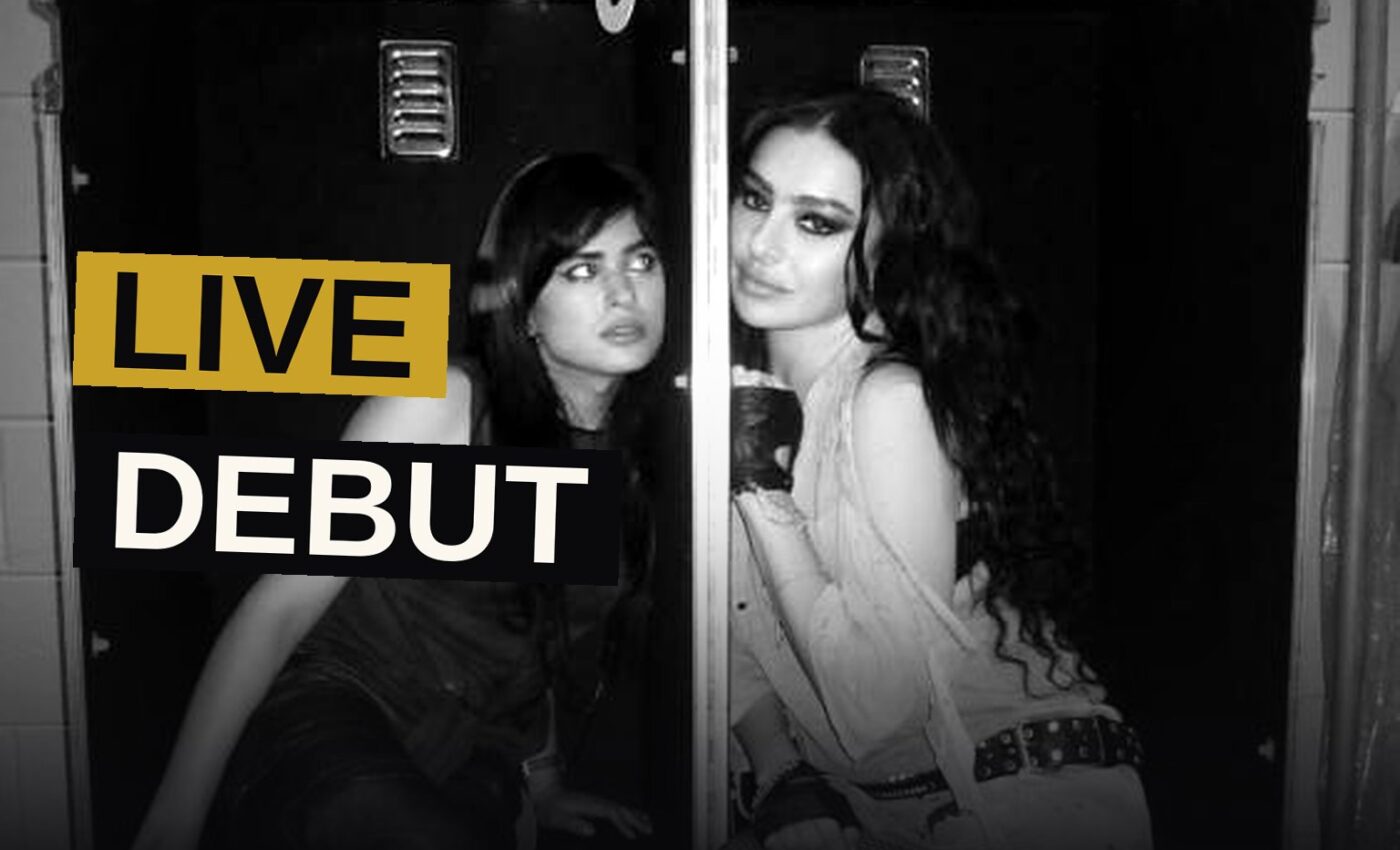 Charli XCX performs on stage with dramatic lighting during her Music, Fashion, Film tour opener.