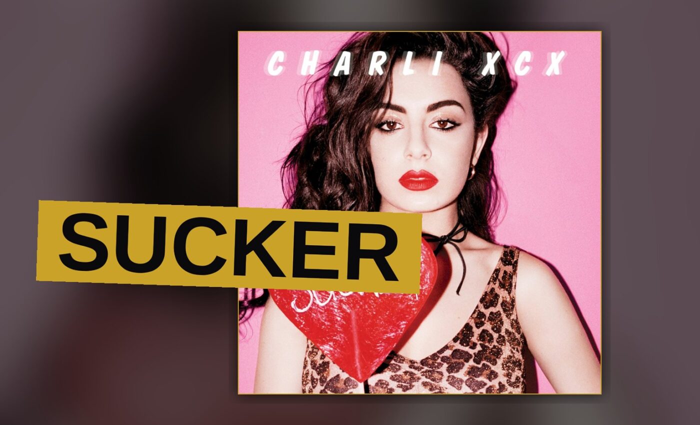A pop star stands under bright colored stage lights, conveying energy and confidence.