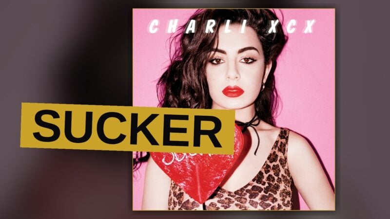 A pop star stands under bright colored stage lights, conveying energy and confidence.