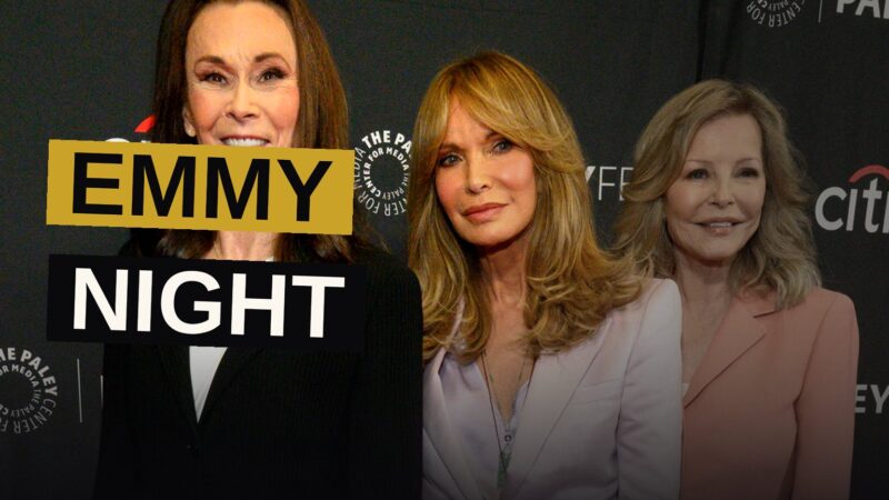 A shimmering Emmy statuette on a red carpet under bright lights at an awards ceremony.
