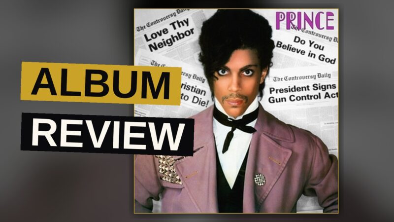 A young Prince in a studio, lit by purple and neon lights, with a synth and guitar nearby.