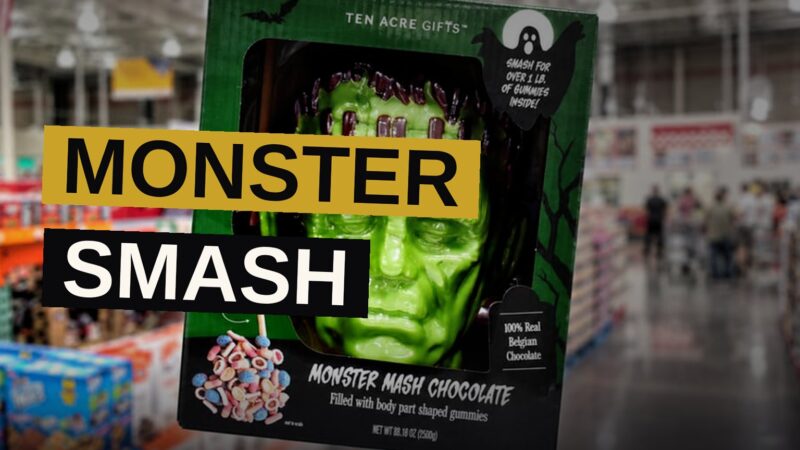 A cracked-open chocolate Frankenstein head with gummy body parts spilling out, next to a wooden mallet.