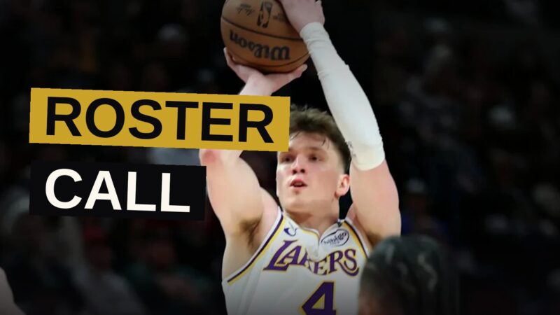 A Lakers player in a purple and gold jersey stands on a basketball court, looking focused under dramatic lighting.