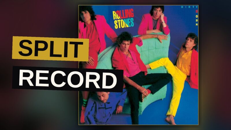 A rock band performs under dim light, guitars raised, evoking a tense, cynical mood.
