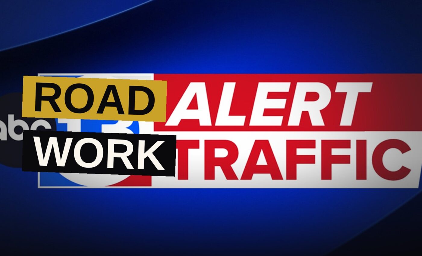 A busy Houston freeway shows lane closures with orange cones and warning lights during weekend construction.