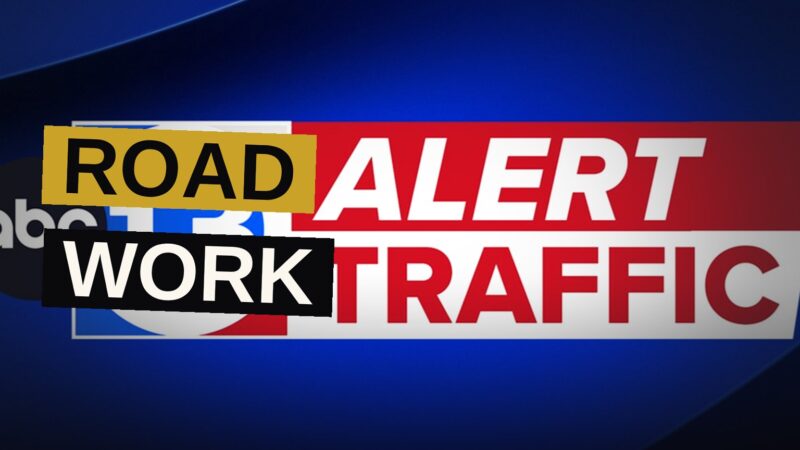 A busy Houston freeway shows lane closures with orange cones and warning lights during weekend construction.