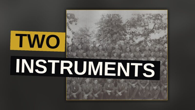 A guitar and drums sit together under dim red light, evoking the heavy, atmospheric sound of the record.