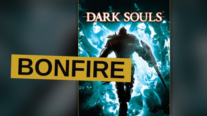 A knight in dark armor stands before a glowing bonfire in a ruined gothic hall.