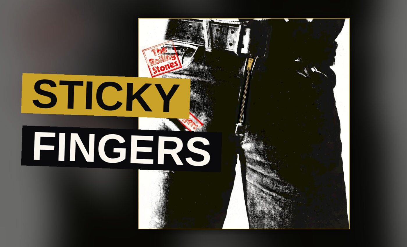 A rock band performs on a dark stage lit by red light.