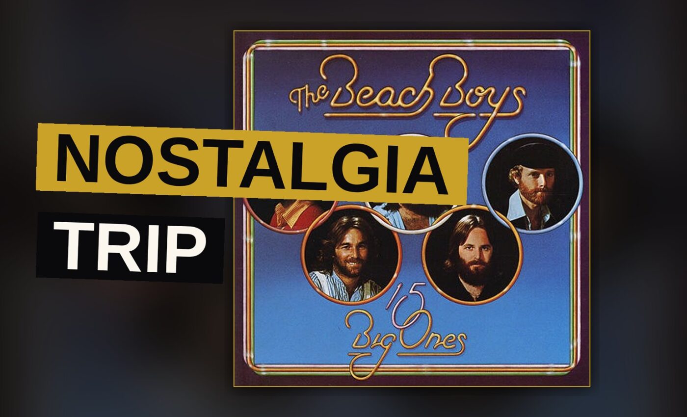 A vintage record player plays a Beach Boys album in a dimly lit room with retro decor.