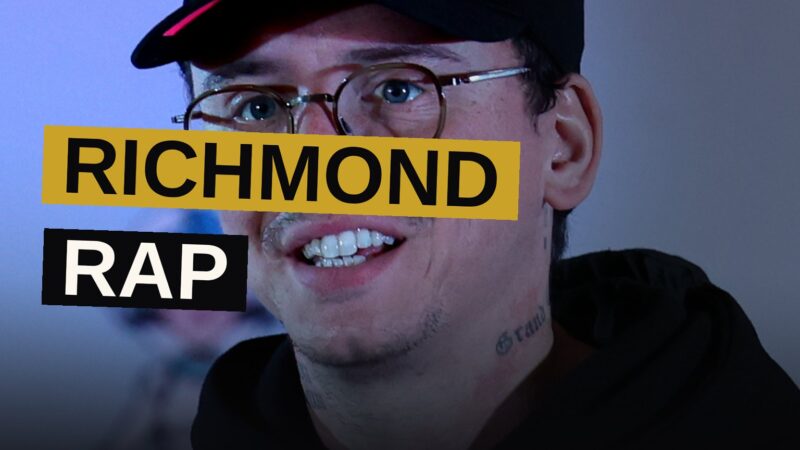 Two rappers stand together under neon street lights, evoking the energy of Richmond hip-hop.