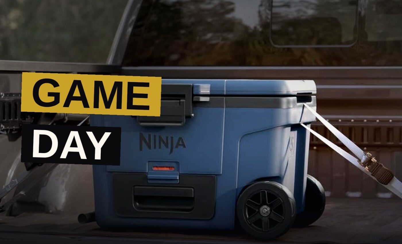 A backyard tailgate setup with a portable grill, cooler, and fire pit ready for game day.