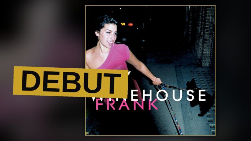 A young singer stands under dim light with a microphone, evoking the soulful mood of her debut album.