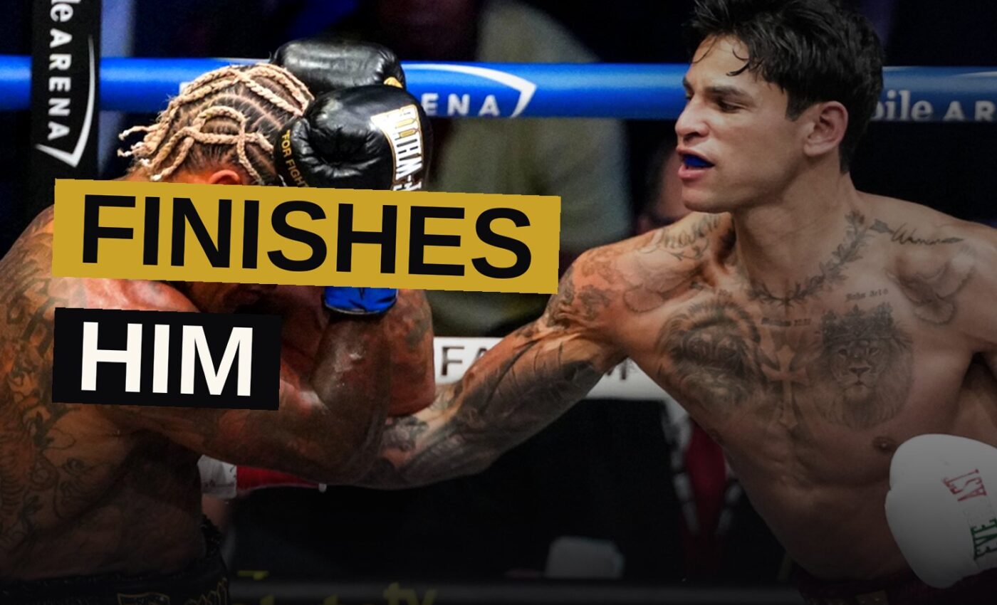 A boxer raises his arms in triumph in the ring after defeating his opponent.