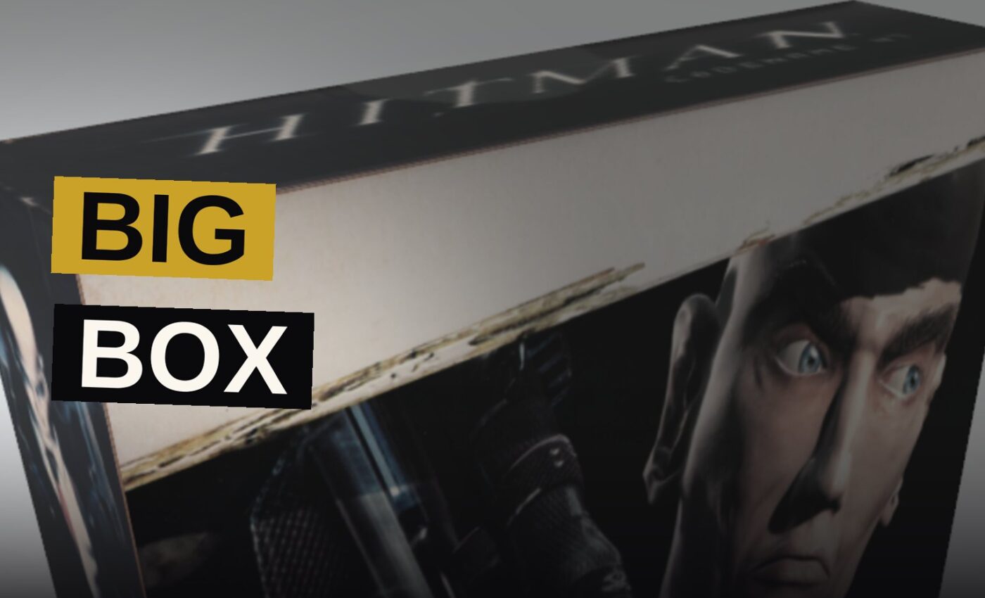 A hand assembles a printed box fashioned after an old PC game's original packaging upon a desk.