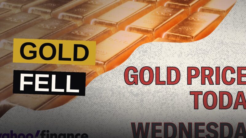 Traders watch glowing screens showing gold and oil charts amid a dark trading floor.