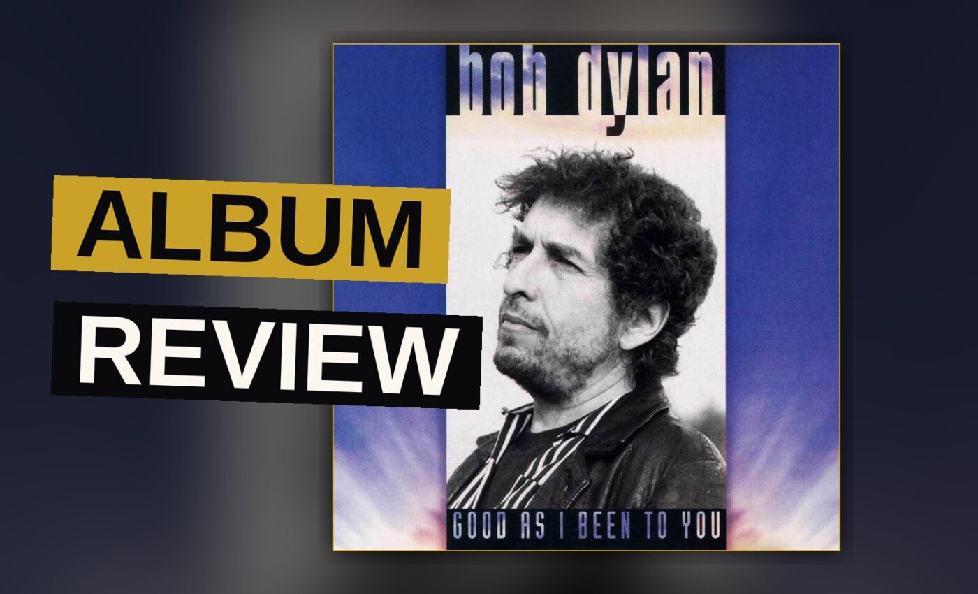 An acoustic guitar and harmonica in a dim garage, evoking a solo folk session.