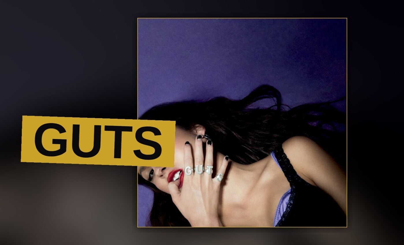 A young singer screams into a microphone under harsh stage light, caught between fury and confession.