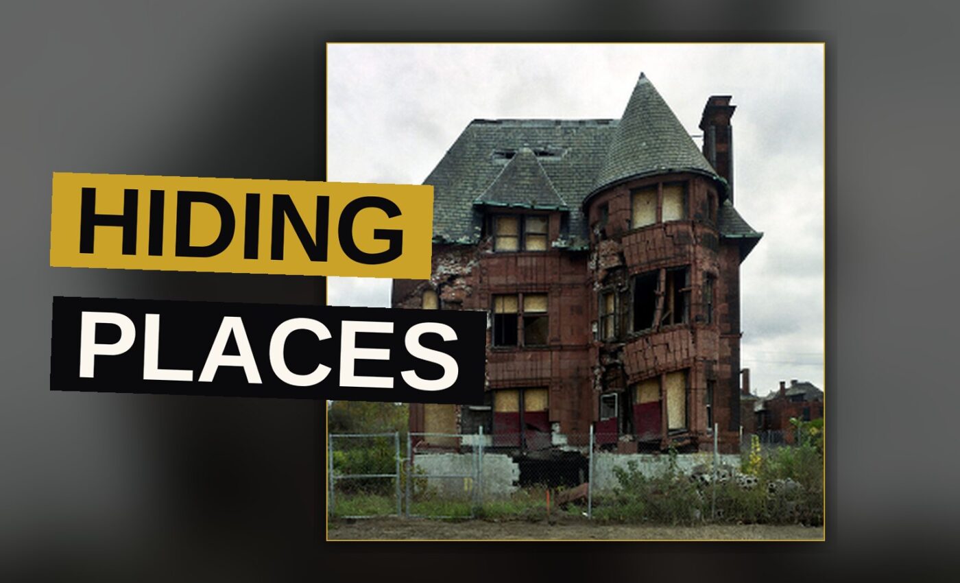 Two rappers perform in a dimly lit studio, conveying a sense of confinement and dread.