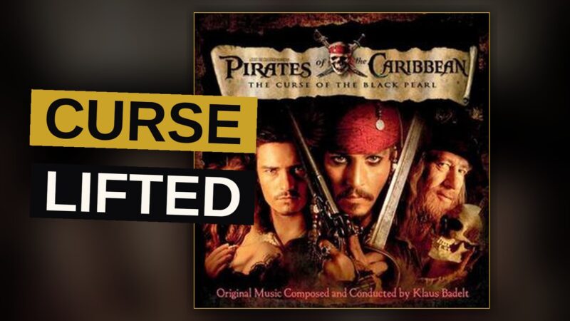 Jack Sparrow with a sword faces skeleton pirates on a moonlit beach.