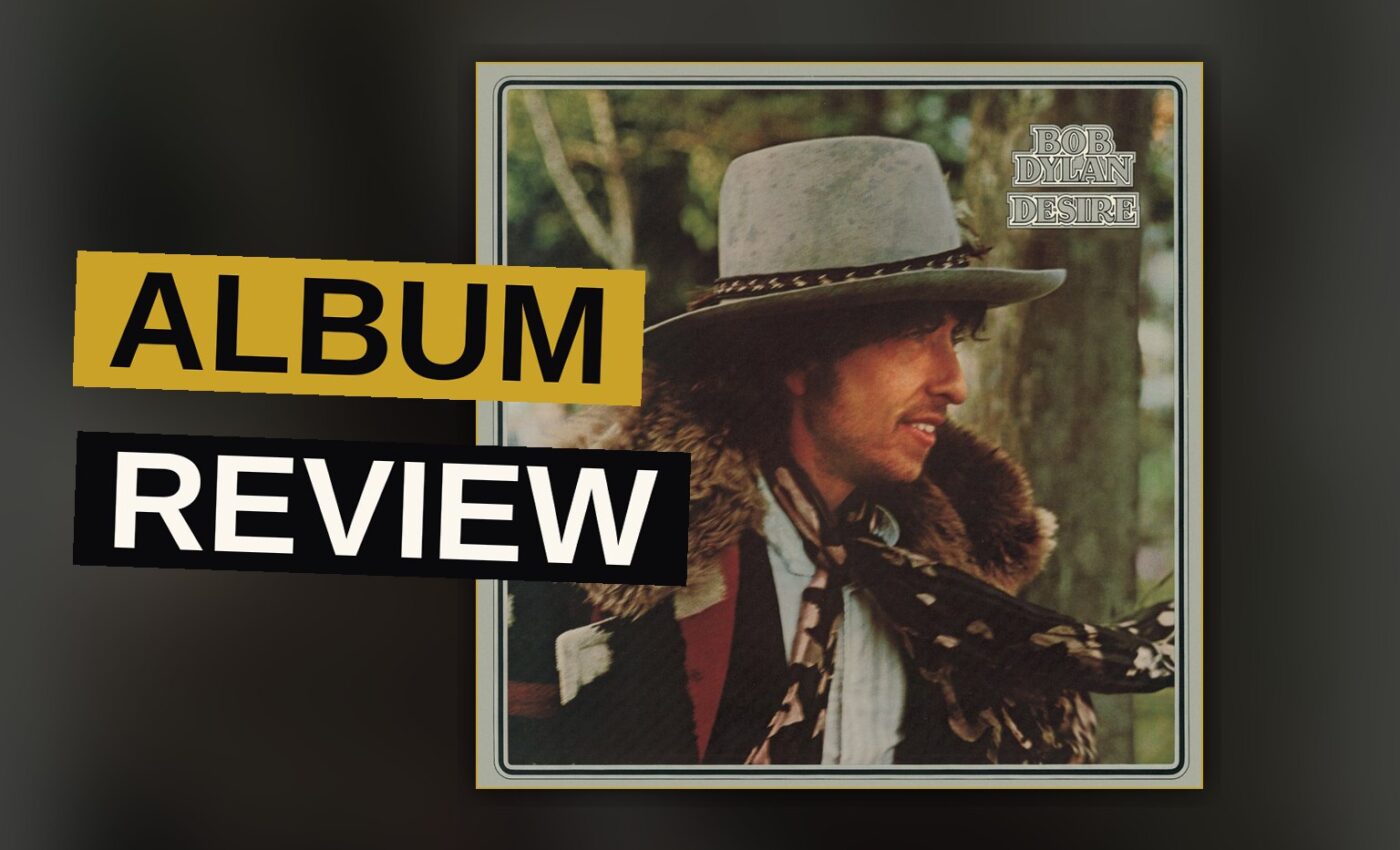 A man in a wide-brimmed hat stands in a smoky, dimly lit room with a violin nearby, evoking a 1970s album cover.