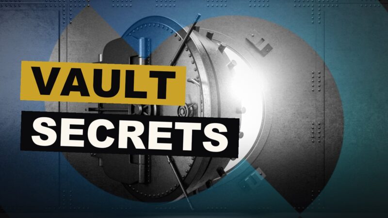 A locked vault box lies open, showing cash, a watch, and a device that guards a secret key, concealed from the eye of the law.