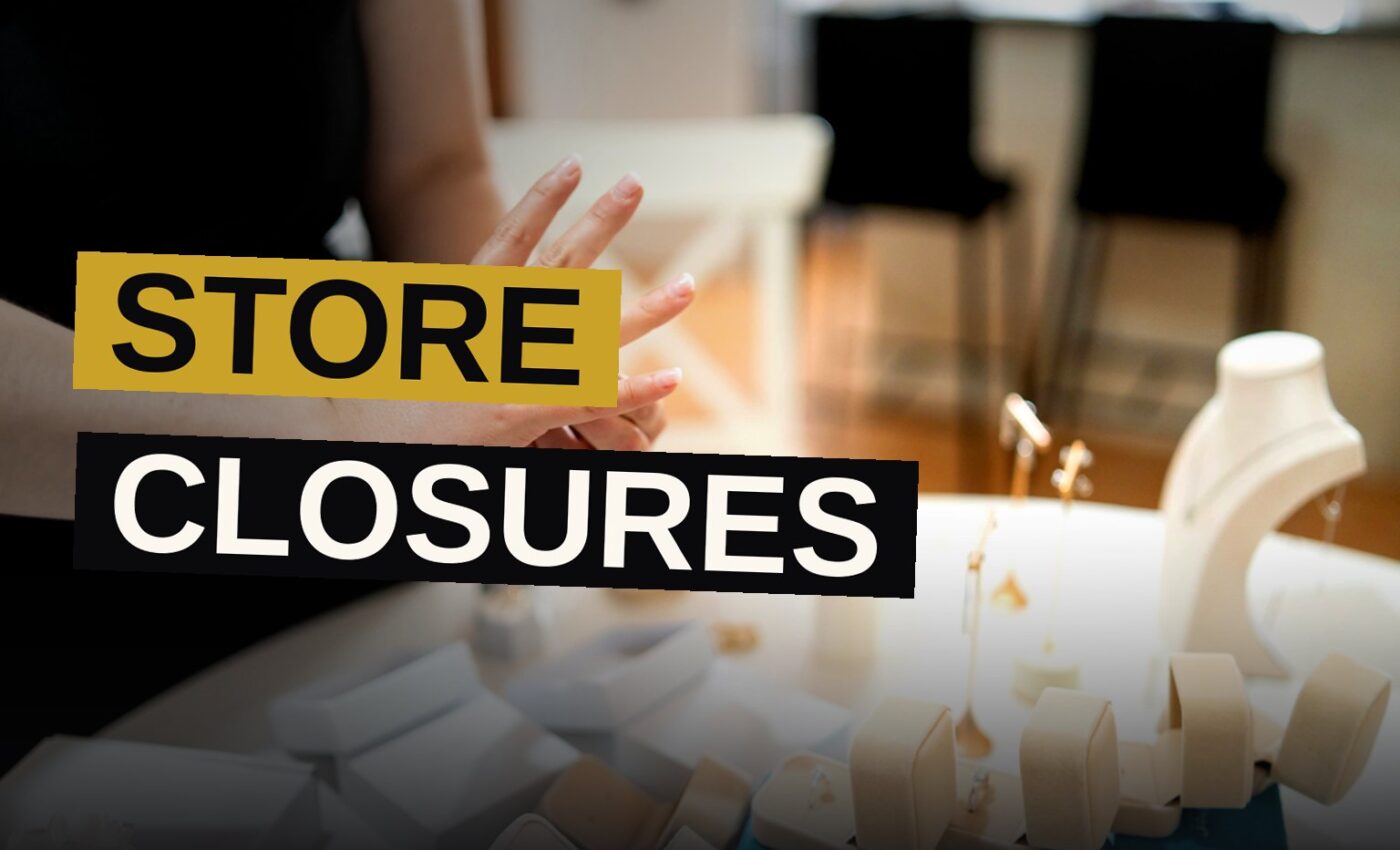 An empty jewelry store with darkened windows and a sign indicating closure.