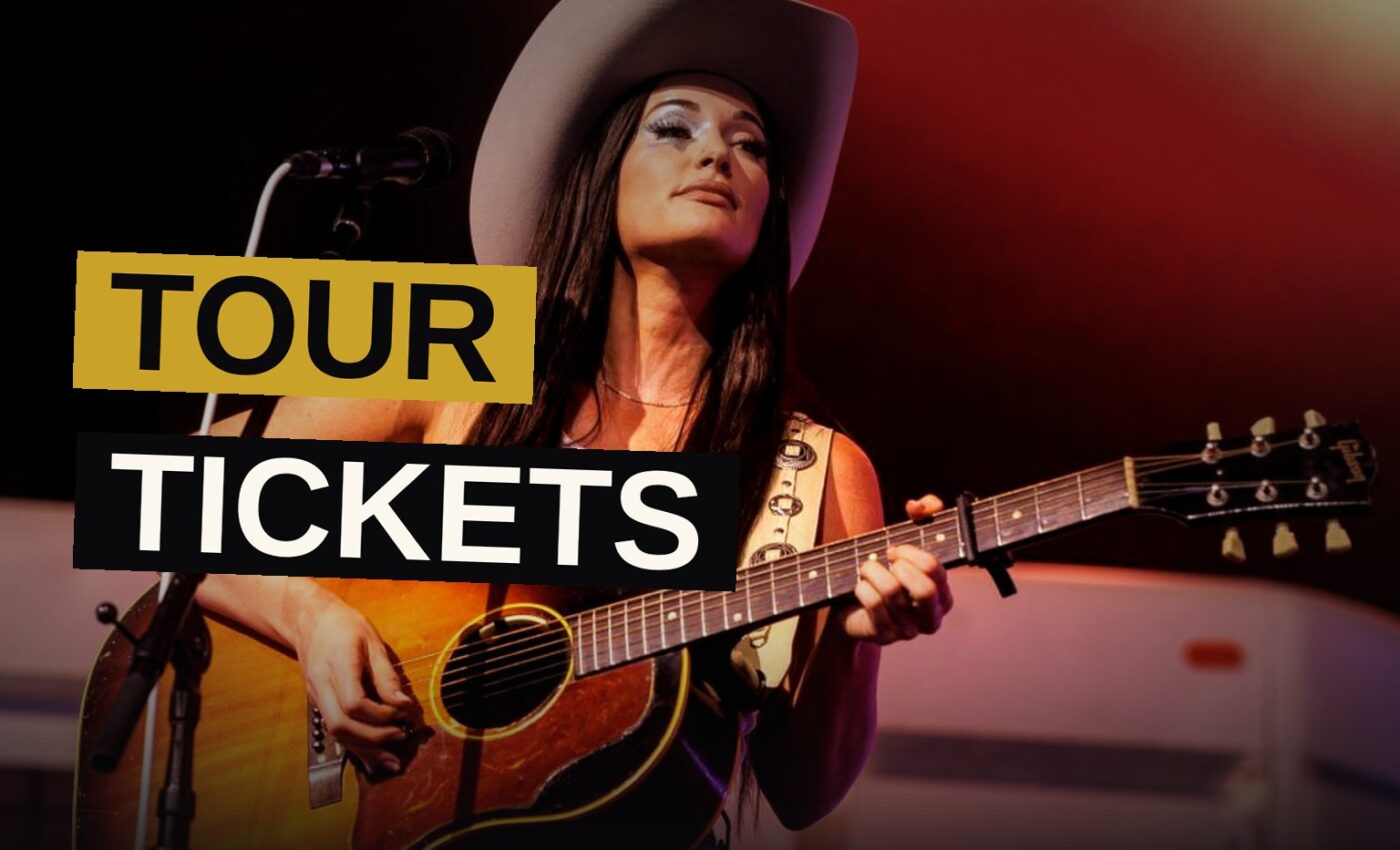 Kacey Musgraves performs on stage under colorful lights with a large disco ball behind her, as fans raise their hands in the crowd.