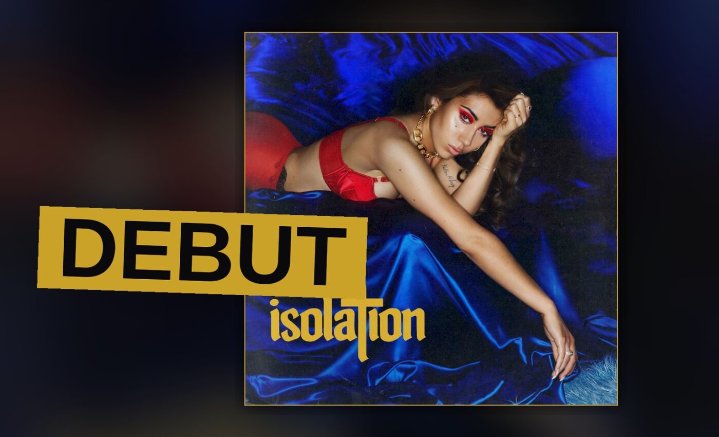 A singer stands in moody neon light, evoking the retro-futurist sound of her debut album.